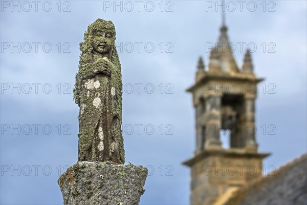 Weathered lichen-covered religious statue in the Chapelle Saint-They at the Pointe du Van