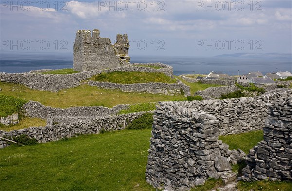 Ruins of a medieval castle between dry stone walls