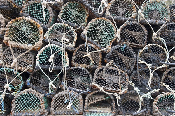 Lobster pots on quayside of harbour