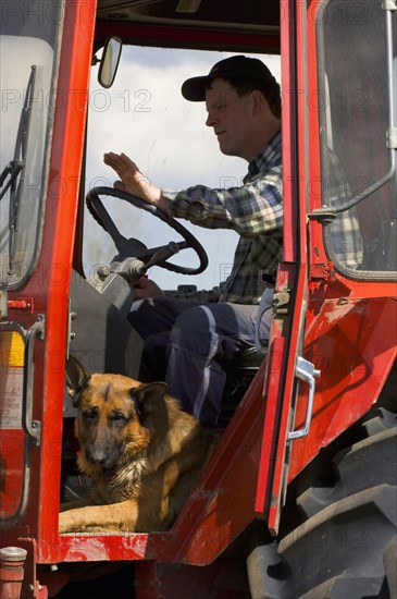 Farmer with German shepherd dog