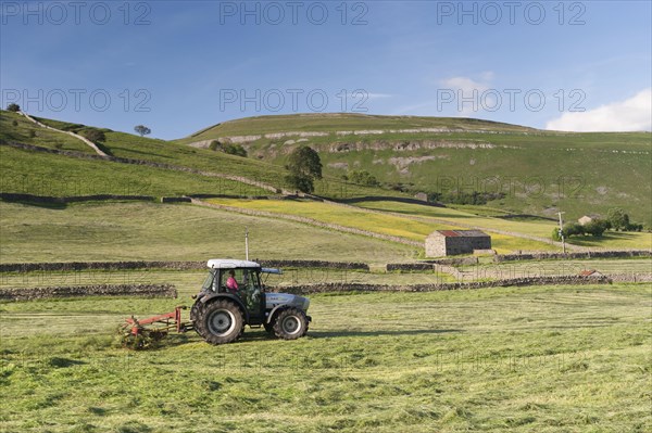 Hurlimann tractor with tedder