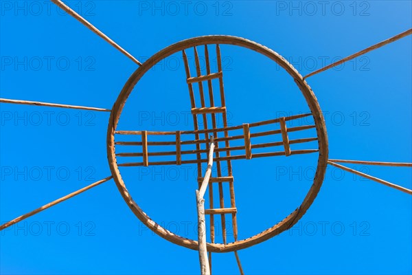 Kazakh men erecting the roof of a yurt