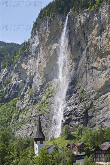 Waterfall flowing over mountain cliff