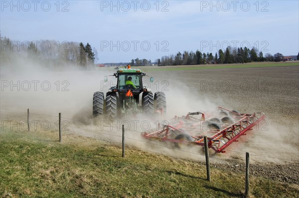 John Deere tractor pulling Vaderstad cultivator