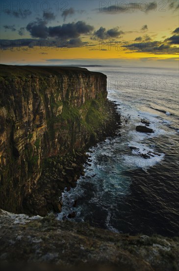 View of sea cliffs at sunset