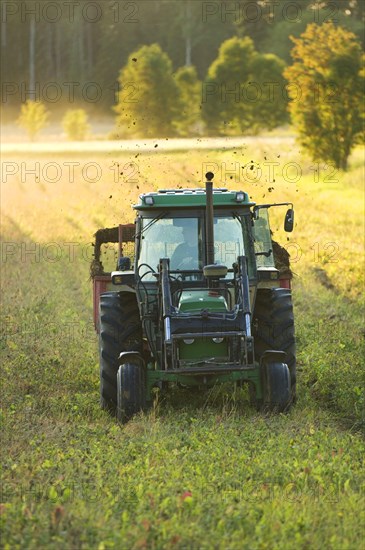 John Deere tractor pulling manure spreader