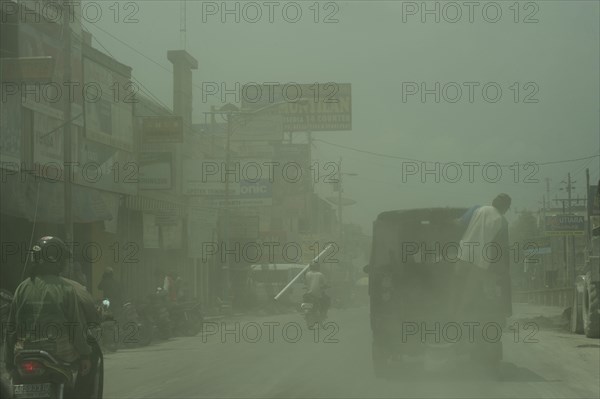 Road with vehicles in ash cloud