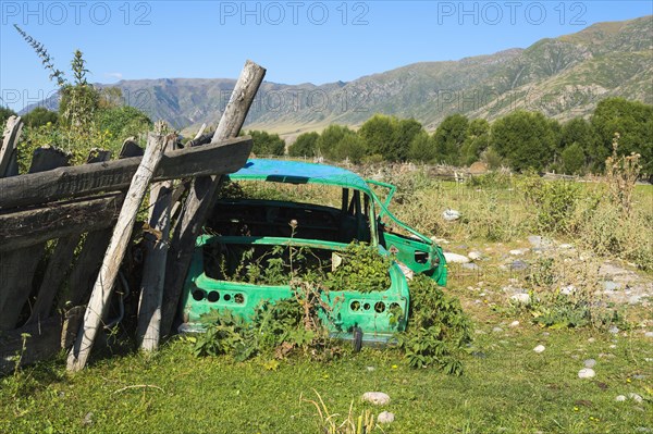 Old abandoned rusted car on a prairie