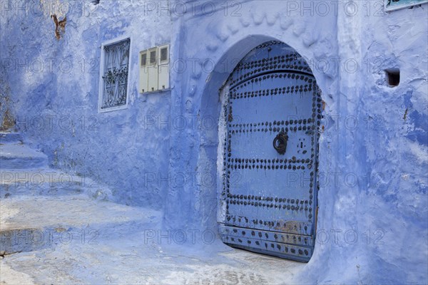 Blue door and stairs in an alley of the city