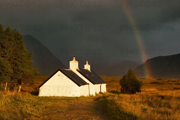 Blackrock hut at dawn with rainbow and gathering storm