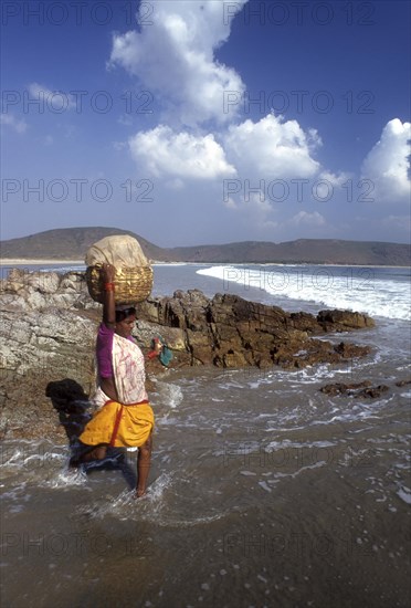 A woman carrying luggage on head in Gangavaram