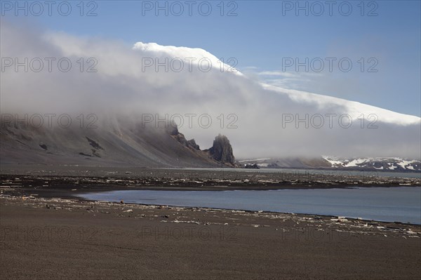 Black sandy beach and snow-covered volcano Beerenberg