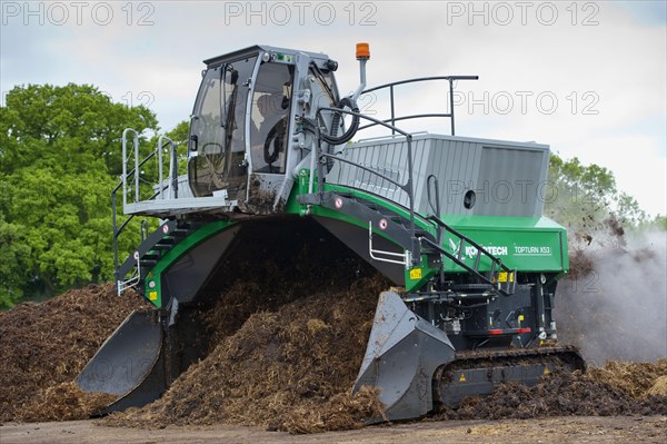 Komptech self-propelled compost turner turning rotting bedding manure