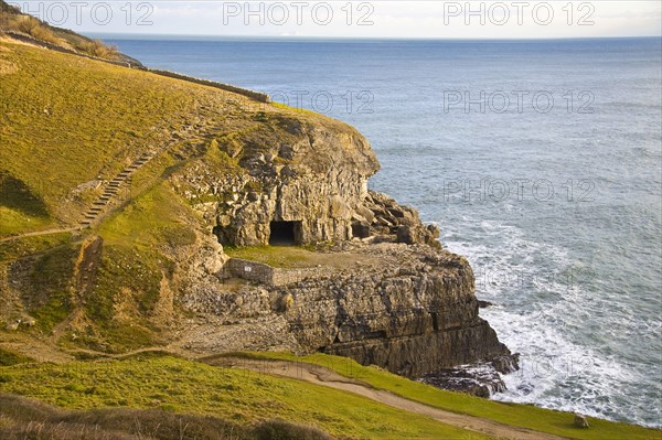 View of coastline with artificial caves in cliff