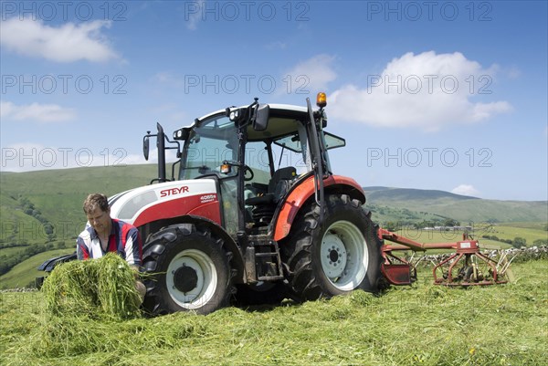 Farmer checks the quality of the mown grass