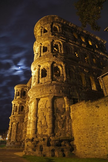 Roman city gate illuminated at night