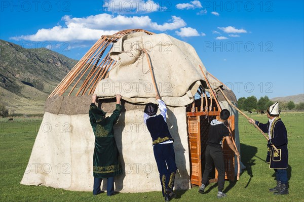 Kazakh men building a yurt