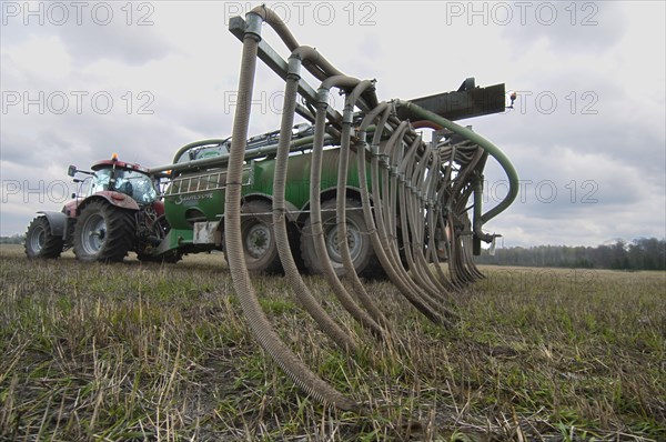 Case 225 Tractor with Samson vacuum slurry tanker and slurry injector injecting slurry into stubble field