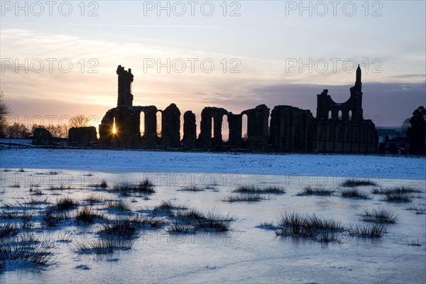 Ruins of the abbey silhouetted at sunset