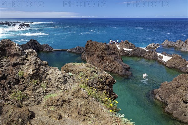 Tourists bathe in natural lava pools