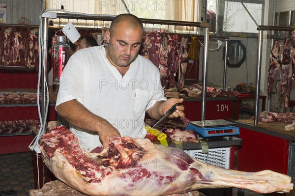 Butcher cutting meat