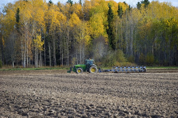 John Deere tractor with eight furrow reversible plough