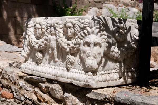 Weathered sarcophagus with relief heads