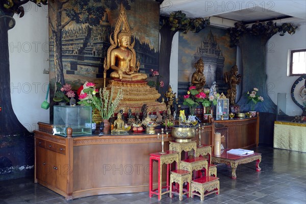 Buddha statue on an altar in a prayer room of the Buddhist monastery Brahma Vihara