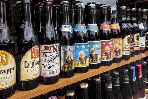 Belgian beers for sale in the window of a liquor shop in Belgium