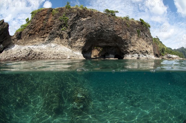 View of sea arch from above and below water