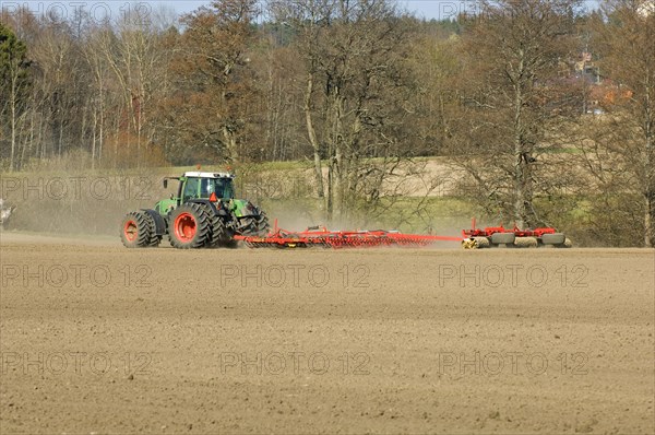 Fendt tractor pulling harrows and rollers