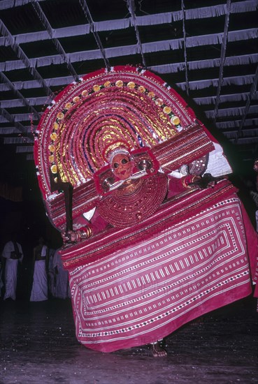 Theyyam or Teyyam ritual dance performing in Kerala Kalamandalam at Cheruthuruthy