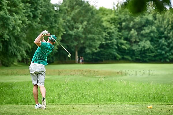 Golfer teeing off a ball