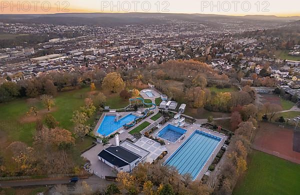 Aerial view of abandoned outdoor pool in front of the big city