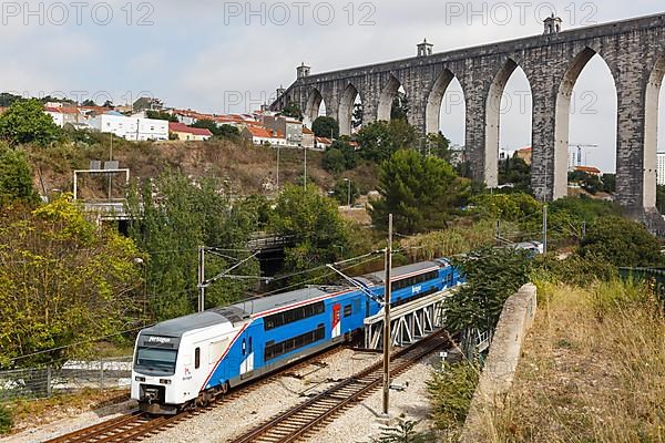 Fertagus train at the aqueduct Aqueduto das Aguas Livres railway in Lisbon