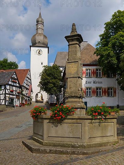 Maximilian Fountain in front of Bell Tower and Restaurant Zur Krim