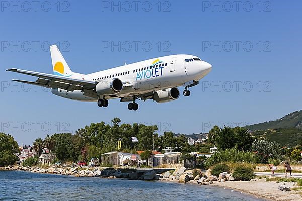 An Aviolet Boeing 737-300 aircraft with registration YU-AND lands at Skiathos Airport