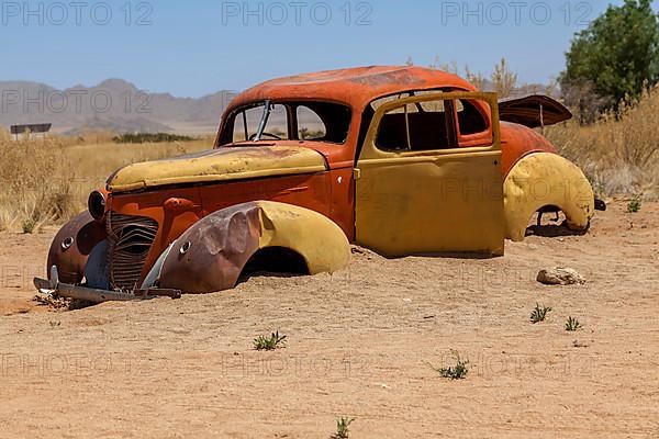 Wreck of a classic car in the desert