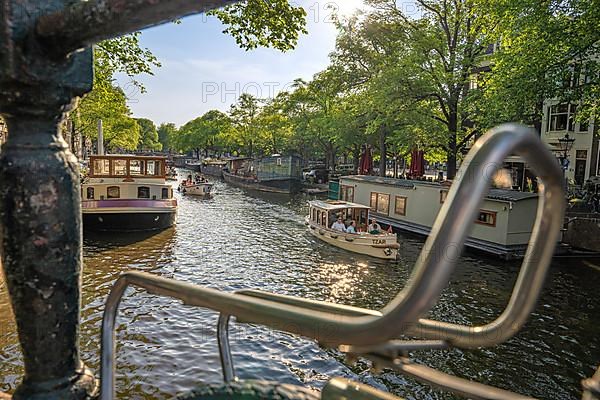 Over a bicycle carrier on the canal to a tourist boat