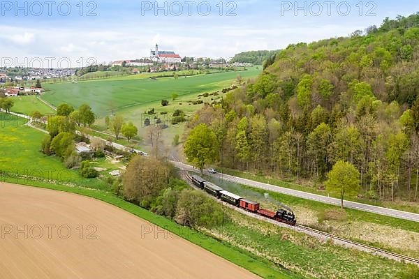 Steam train of the Haertsfeld Museumsbahn Schaettere aerial view railway steam train with Neresheim monastery