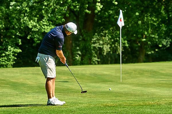 Golfer putting a ball