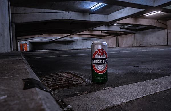 Empty Becks can standing in an empty and dirty car park in the city centre