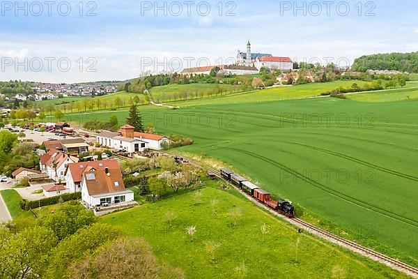 Steam train of the Haertsfeld Museumsbahn Schaettere aerial view railway steam train with Neresheim monastery