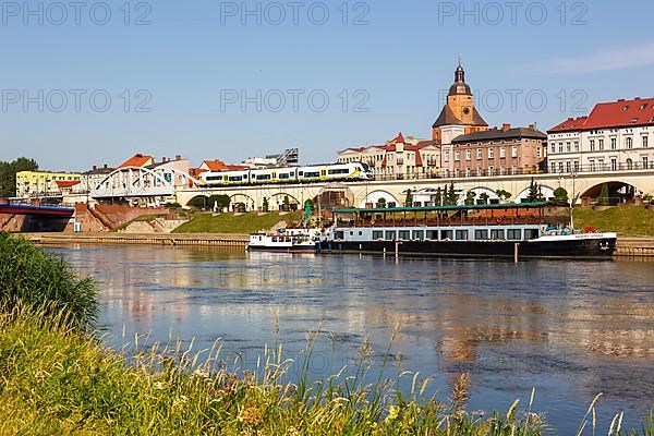 Landsberg an der Warthe town on the river with a Newag Impuls 2 regional train in Gorzow Wielkopolski