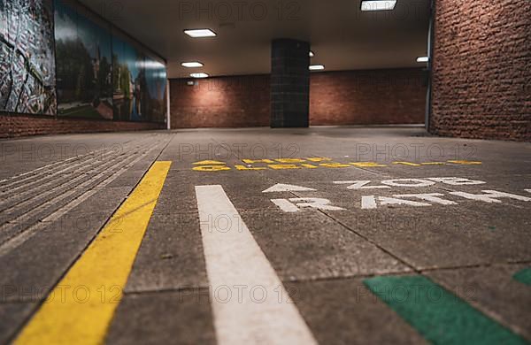 Railway station subway with signs on the ground