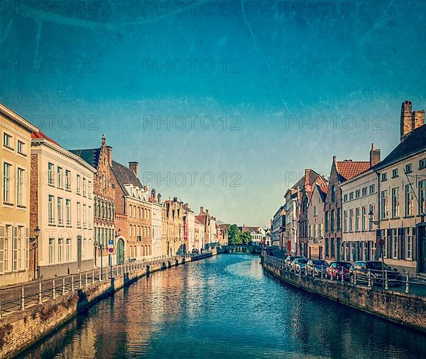 Vintage retro hipster style travel image of canal and medieval houses. Bruges