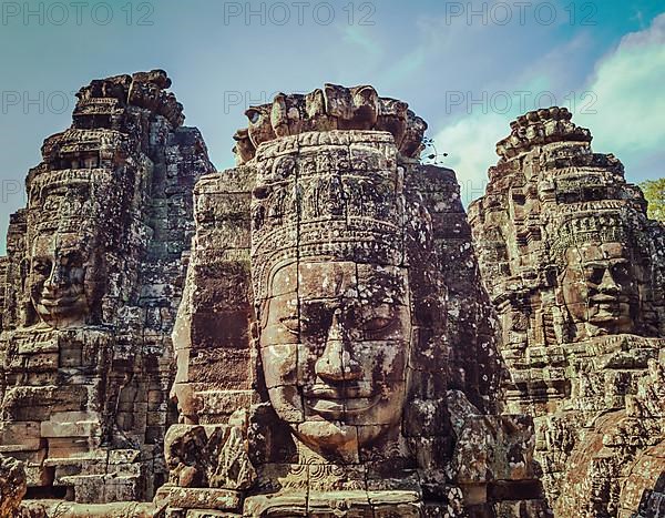 Vintage retro effect filtered hipster style travel image of ancient stone faces of Bayon temple