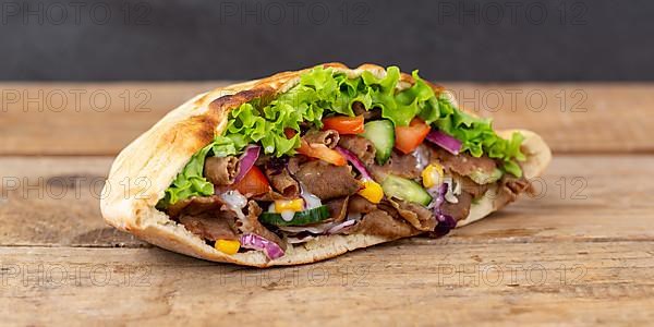 Doener Kebab Doner Kebap fast food in pita bread on wooden board Panorama in Stuttgart