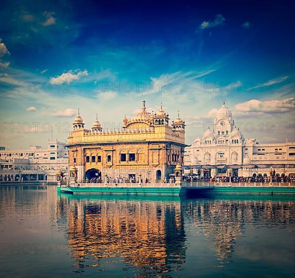 Vintage retro hipster style travel image of famous India attraction Sikh gurdwara Golden Temple