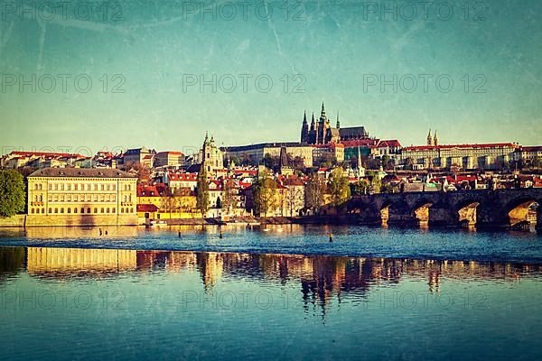 Vintage retro hipster style travel image of Mala Strana and Prague castle over Vltava river with grunge texture overlaid. Prague